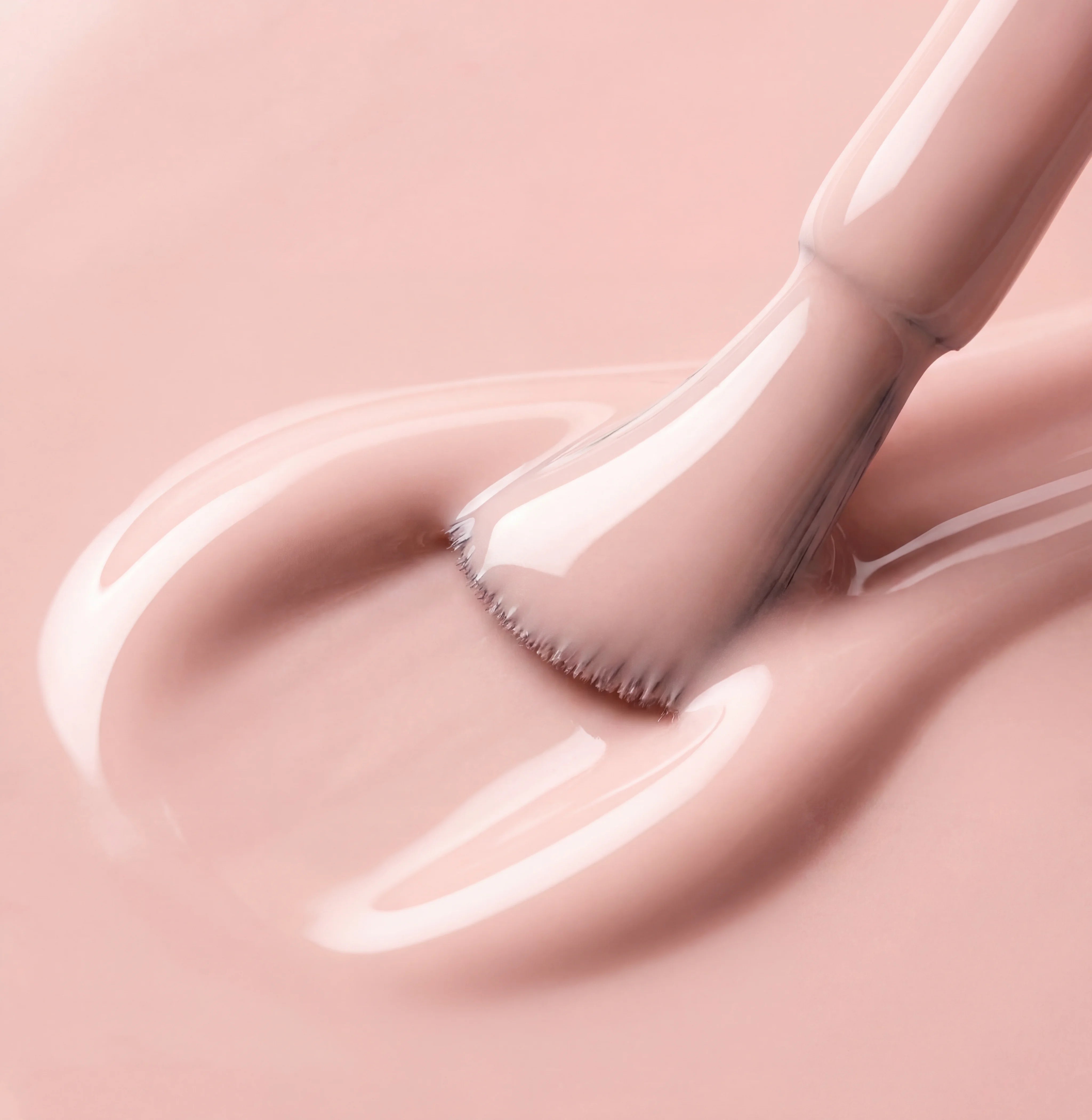 Makeup brush with pink cream on a matching pink background